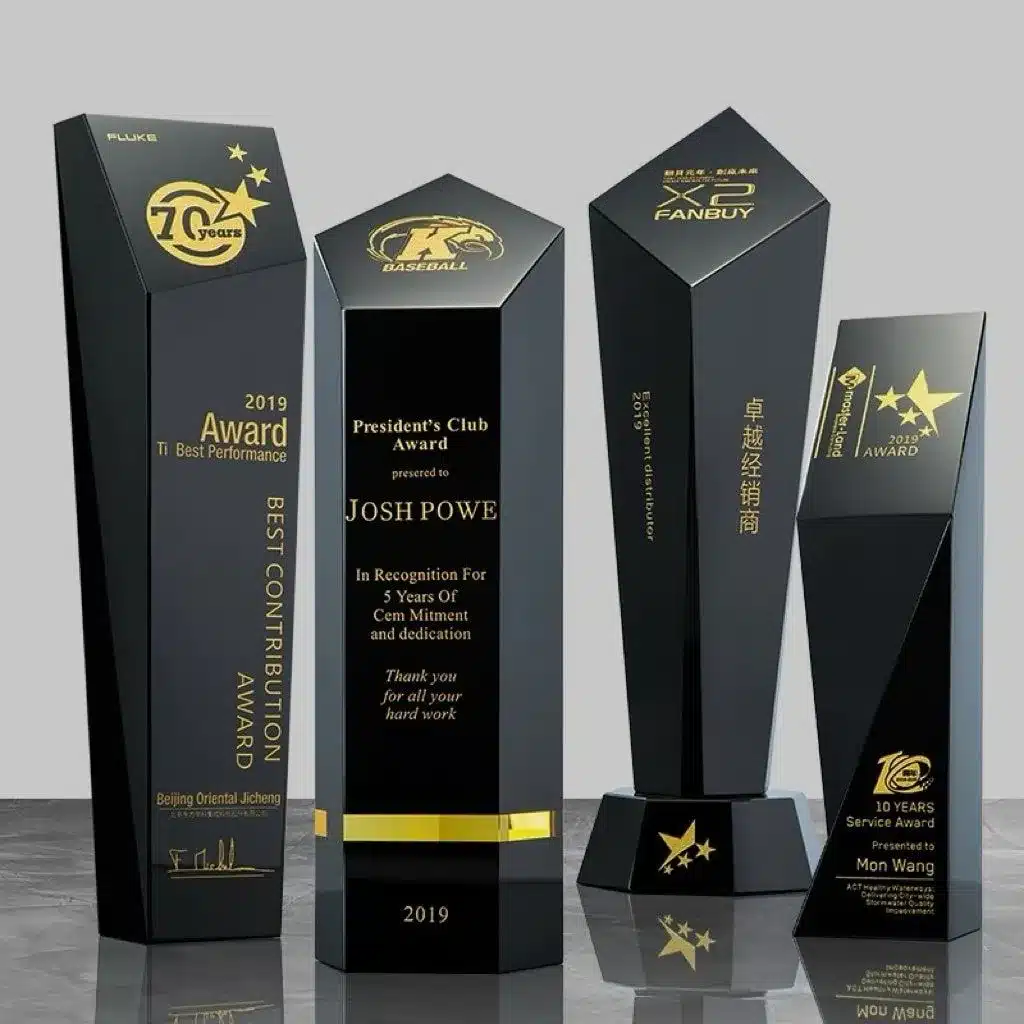 Modern black acrylic trophies with gold engraving and custom award designs