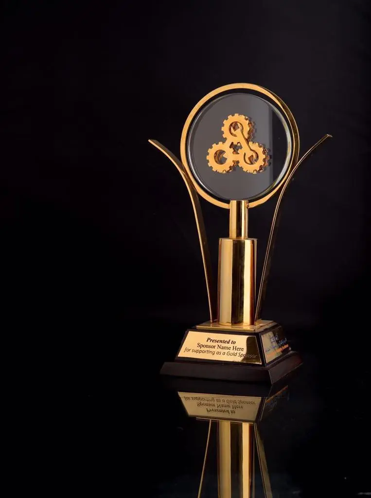 Gold-plated metal trophy with clear crystal and black base
